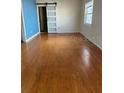 Spacious living room with rich hardwood floors and a unique sliding barn door at 1379 Pine St, Clearwater, FL 33756