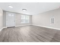 Bright living room featuring stylish gray flooring, fresh paint, and recessed lighting at 13926 Helen Ave, Hudson, FL 34667