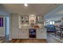 Charming bar area with custom cabinetry, granite counters and a beverage refrigerator at 1460 Gulf Blvd # 305, Clearwater, FL 33767
