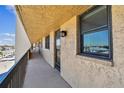 Hallway with brown railing on the condominium exterior at 14900 Gulf Blvd # 212, Madeira Beach, FL 33708