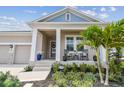 Charming front porch with rocking chairs, manicured landscaping, and welcoming curb appeal at 1499 Gopher Loop, Tarpon Springs, FL 34689