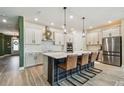 Modern kitchen with stainless steel appliances, island with seating and ample cabinet space at 1499 Gopher Loop, Tarpon Springs, FL 34689