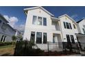 Beautiful two-story home with white siding and black trim on a sunny day at 1631 Springwell Ln, Sarasota, FL 34240