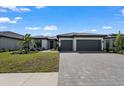 Charming single-Gathering home with a tile roof, two-car garage, and a well-maintained front yard at 1797 Pepper Grass Dr, North Port, FL 34289