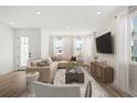 Bright living room featuring stylish furniture, a large TV, and modern decor at 2019 Wild Heron Ct, Valrico, FL 33596
