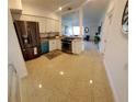 Bright kitchen features stainless steel appliances, white cabinetry, and speckled countertops at 2204 Euclid S Cir, Clearwater, FL 33764