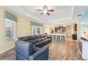 Expansive living room showcasing an open layout with kitchen access and a comfortable sectional sofa at 2417 Cumberland Cliff Dr, Ruskin, FL 33570