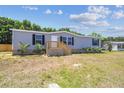 Well-kept single-story home boasts a manicured lawn and inviting entrance, enhanced by lush landscaping at 25126 Huston St, Brooksville, FL 34601
