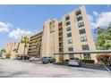 Multi-story condo building featuring covered parking, balconies, and a well-maintained facade at 2617 Cove Cay Dr # 401, Clearwater, FL 33760