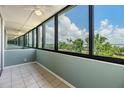 Enclosed sunroom with tile flooring and panoramic views of the outdoors and water at 2617 Cove Cay Dr # 401, Clearwater, FL 33760