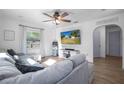 Bright living room features a comfortable sofa and archway to a cozy bedroom at 267 Broad St, Brooksville, FL 34604