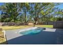 Private backyard featuring a sparkling in-ground pool and lush landscaping for ultimate relaxation at 267 Broad St, Brooksville, FL 34604
