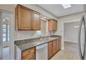 Bright kitchen with granite countertops, stainless steel appliances, and wooden cabinets at 2961 Briar Cliff Dr, Palm Harbor, FL 34684