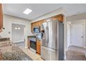 Well-equipped kitchen featuring stainless steel appliances, granite countertops, and ample cabinet space at 2961 Briar Cliff Dr, Palm Harbor, FL 34684