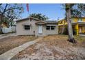 Inviting single-story home with awnings and a walkway leads to a decorative door frame at 306 S Highland Ave, Clearwater, FL 33755