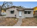 Inviting front exterior with a walkway, awnings, and decorative door frame at 306 S Highland Ave, Clearwater, FL 33755