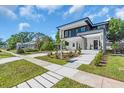 Contemporary home boasts modern design, a meticulously landscaped yard, and inviting walkway at 3175 10Th N Ave, St Petersburg, FL 33713