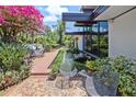 Zen-like backyard with water feature, lush garden, and outdoor seating area at 3501 S Drexel Ave, Tampa, FL 33629