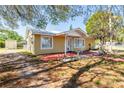 View of a charming single-story home featuring a well-maintained yard at 3823 N 56Th St, Tampa, FL 33619