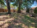 The spacious backyard features mature trees and lush greenery at 4708 W Ballast Point Blvd, Tampa, FL 33611