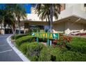 Well-manicured entrance to the Columbia building with lush landscaping and clear signage at 4725 Cove Cir # 601, St Petersburg, FL 33708