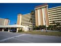 Low angle view of the Columbia building showcasing its facade and parking at 4725 Cove Cir # 601, St Petersburg, FL 33708