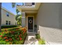 Charming front entrance with a decorative wreath, lush landscaping, and a covered porch at 5276 6Th N Way, St Petersburg, FL 33703