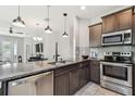 Modern kitchen featuring stainless steel appliances, granite countertops, and stylish pendant lighting at 5276 6Th N Way, St Petersburg, FL 33703