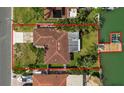 An aerial view of a waterfront home, including dock, framed within the property line at 543 Crystal Dr, Madeira Beach, FL 33708