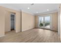 Bright living room featuring new flooring, neutral walls, and glass doors to the backyard at 543 Crystal Dr, Madeira Beach, FL 33708