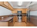 A well-equipped kitchen features stainless steel appliances and natural wood cabinets at 581 Oceanview Ave, Palm Harbor, FL 34683
