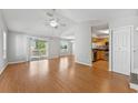 Bright and airy living room with vaulted ceilings and a sliding glass door leading to a deck at 581 Oceanview Ave, Palm Harbor, FL 34683