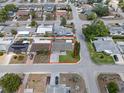 Aerial view of a single-Gathering home with a lawn, driveway, and neighborhood at 5821 Thrush Dr, New Port Richey, FL 34652