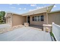 Inviting front entrance with stone pillars, modern lighting, and an arched front door, enhancing curb appeal at 5821 Thrush Dr, New Port Richey, FL 34652