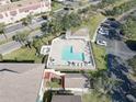 Aerial view of community pool, showcasing ample lounge seating and surrounding green space at 6330 99Th N Way # 14F, St Petersburg, FL 33708