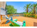 Inviting outdoor deck area complete with Adirondack chairs and a beautiful lake view at 709 47Th E St, Bradenton, FL 34208
