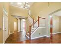 Spacious foyer featuring tile and hardwood floors, staircase, chandelier, and ample natural light at 7310 Brightwater Oaks Dr, Tampa, FL 33625