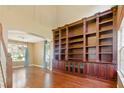 Elegant living room featuring hardwood floors, tall bookcase, and natural light at 7310 Brightwater Oaks Dr, Tampa, FL 33625