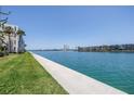 Serene water view showcasing the building's waterfront location, beautiful landscaping, and the tranquil canal at 7625 Sun Island S Dr # 106, South Pasadena, FL 33707