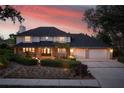 Stunning two-story home with a well-manicured lawn and a three-car garage at 101 Ponce De Leon Blvd, Belleair, FL 33756