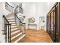 Elegant foyer with a curved staircase and abundant natural light at 101 Ponce De Leon Blvd, Belleair, FL 33756