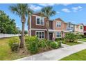 Desirable townhome featuring a landscaped yard and beautiful curb appeal at 1116 Martin Luther King Jr Ave, Dunedin, FL 34698