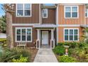 Charming townhome with colorful exteriors, a landscaped yard, and inviting front entrance at 1116 Martin Luther King Jr Ave, Dunedin, FL 34698