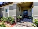 Inviting front porch with stone accents and lush landscaping at 12407 Hilltop Farms Dr, Dade City, FL 33525