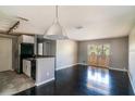Open living area with black appliances, tile and dark wood floors, and sliding glass doors at 1400 Gandy N Blvd # 708, St Petersburg, FL 33702