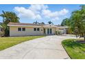 Inviting home exterior with a large driveway and well-maintained lawn at 1524 Carson Ne Cir, St Petersburg, FL 33703