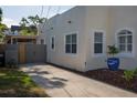 Spacious driveway and side view of a single-Gathering home with access to a screened-in area at 1606 S Arrawana Ave, Tampa, FL 33629