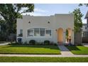 Lovely single-Gathering home with a well-kept lawn, large window, and an inviting arched doorway at 1606 S Arrawana Ave, Tampa, FL 33629