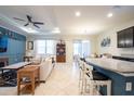Bright living room featuring an open floor plan, ceiling fan, and access to the dining area at 16313 Treasure Point Dr, Wimauma, FL 33598