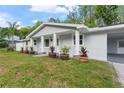 Attractive single-story home with a columned entryway and lush landscaping at 16411 Lake Byrd Dr, Tampa, FL 33618